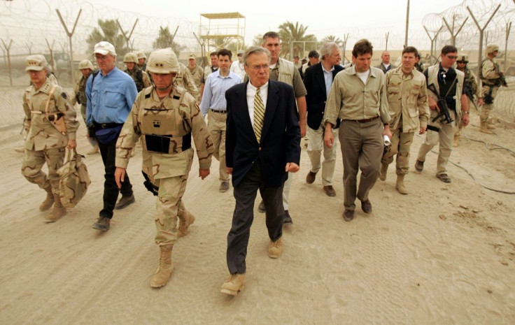 US Defense Secretary Donald Rumsfeld walks the grounds of the Abu Ghraib prison near Baghdad in May 2004