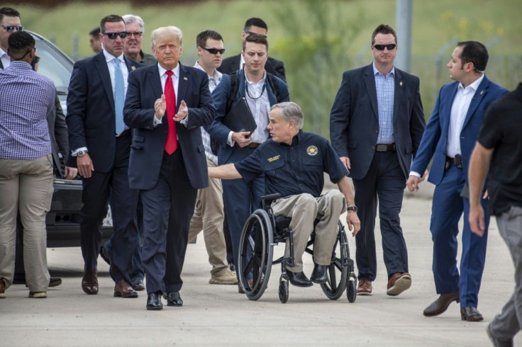 Former US president Donald Trump was accompanied by Texas Governor Greg Abbott (C) for a visit to a section of the border wall near Pharr, Texas
