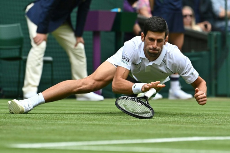 Down but not out: Novak Djokovic falls during his win over South Africa's Kevin Anderson