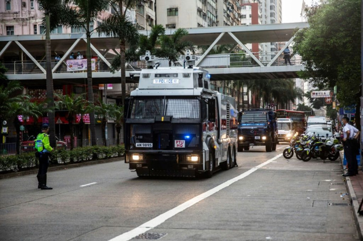 Police and water cannon trucks patrol streets near the official ceremony