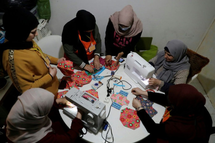 Members of international NGO Days For Girls and local partner WingWoman Lebanon train refugee women to make reusable sanitary pads out of colourful cloth in Beirut's Shatila Palestinian refugee camp