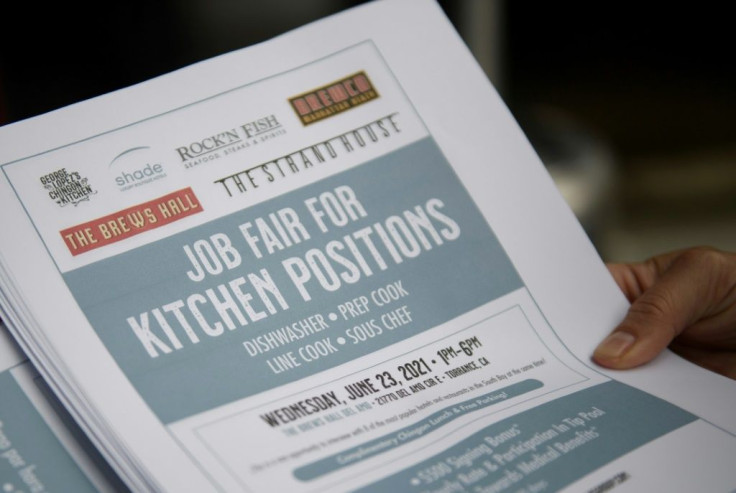 In this file photo taken on June 23, 2021, an employer holds flyers for hospitality employment during a Zislis Group job fair at The Brew Hall in Torrance, California