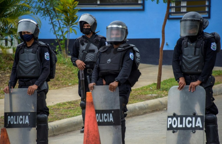 Riot police stand guard outside El Chipote on June 30, 2021