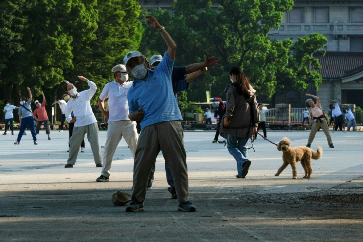 A group takes part in a morning radio taiso exercise in a Tokyo park