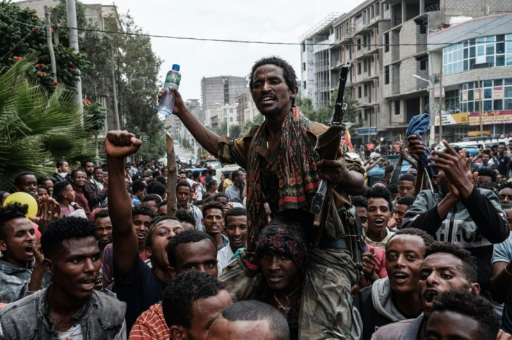 Jubilant supporters hold the returning fighters aloft as they march through the streets of Mekele