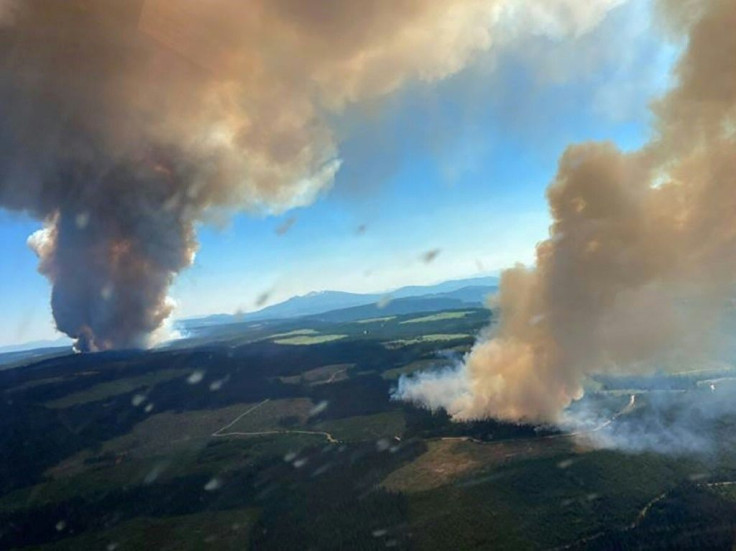 This handout photo courtesy of BC Wildfire Service shows two plumes of smoke from the Long Loch wildfire and the Derrickson Lake wildfire, British Columbia, on June 30, 2021