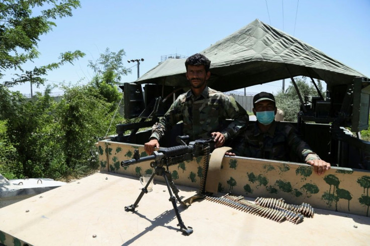 Afghan National Army (ANA) soldiers stand guard at a road checkpoint outside Bagram Air Base, after all US and NATO troops left