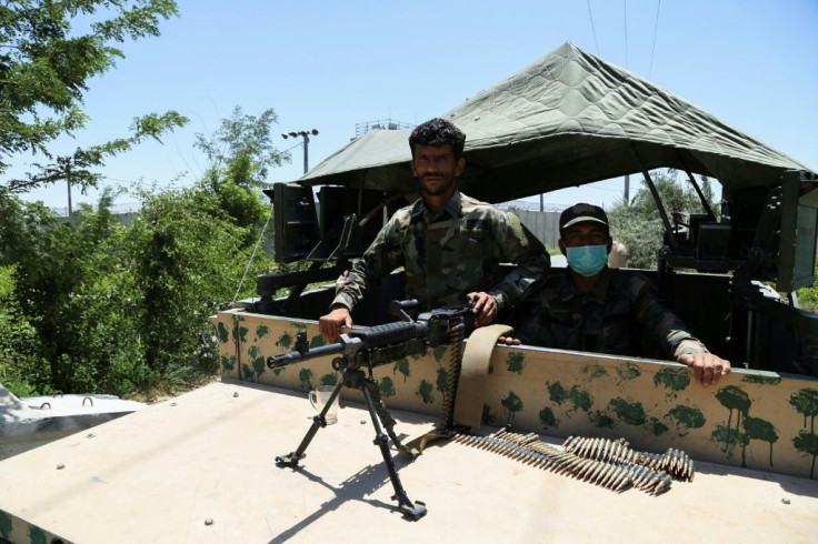 Afghan National Army (ANA) soldiers stand guard at a road checkpoint outside Bagram Air Base, after all US and NATO troops left