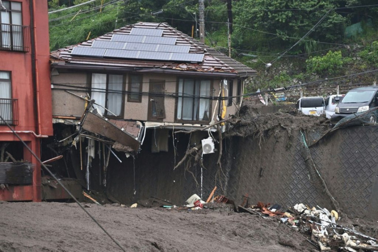 An air-conditioning unit dangled from one devastated home with solar panels on the roof