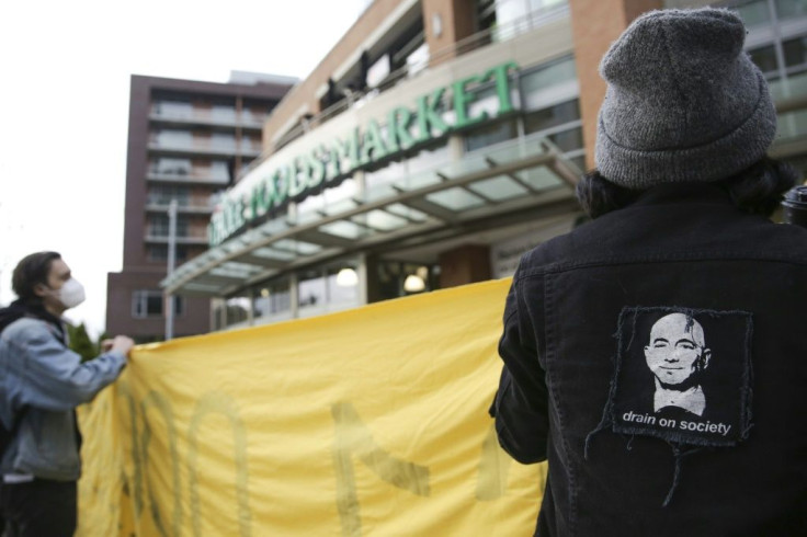 An image of Amazon founder and CEO Jeff Bezos is pictured on a jacket as people rally rally outside a Whole Foods Market in solidarity with Amazon workers in Bessemer, Alabama, who hope to unionize, in Seattle, Washington on March 26, 2021