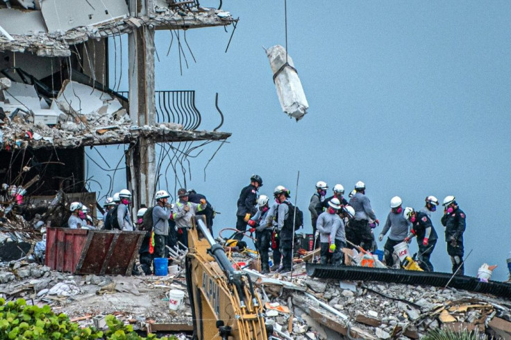 Search and Rescue teams look for survivors in the partially collapsed 12-story Champlain Towers South condo building on June 30, 2021 in Surfside, Florida