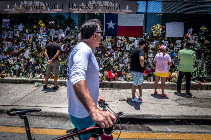 People look at a memorial to the disaster