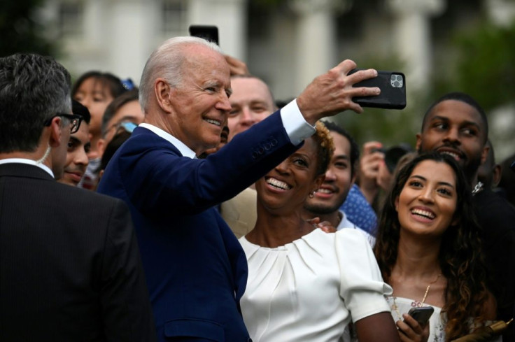 US President Joe Biden poses for a selfie with guests after delivering a speech during Independence Day celebrations on the South Lawn of the White House