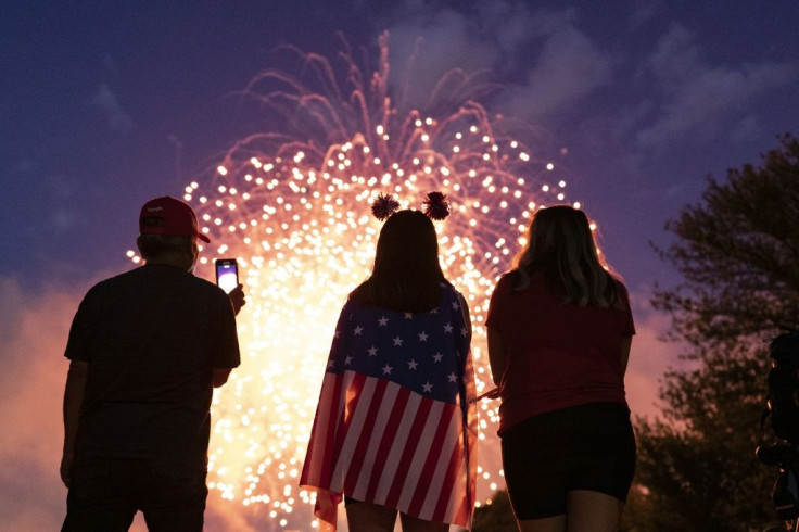 Visitors watch the Independence Day fireworks display near the Lincoln Memorial on the National Mall on July 4, 2021 in Washington, DC