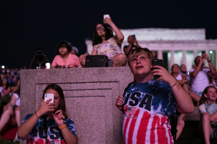Visitors watch the Independence Day fireworks display near the Lincoln Memorial on the National Mall on July 4, 2021 in Washington, DC