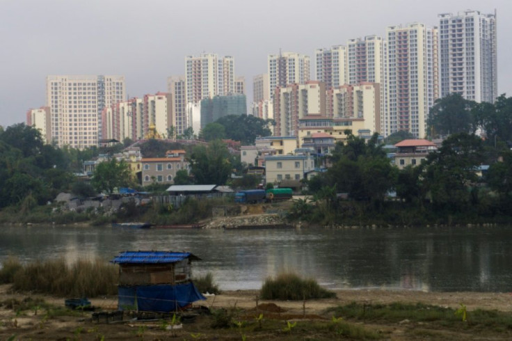 The Chinese city of Ruili (background) is a major crossing point from the town of Muse in Myanmar (foreground)