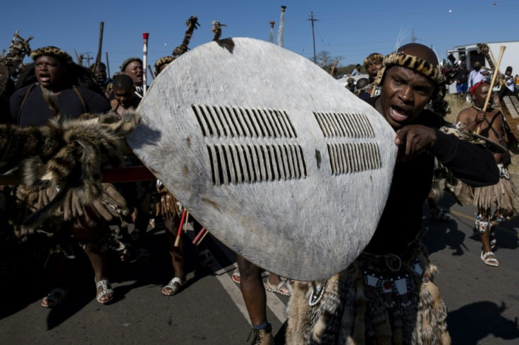 Supporters hold up a Zulu shield outside Zuma's home