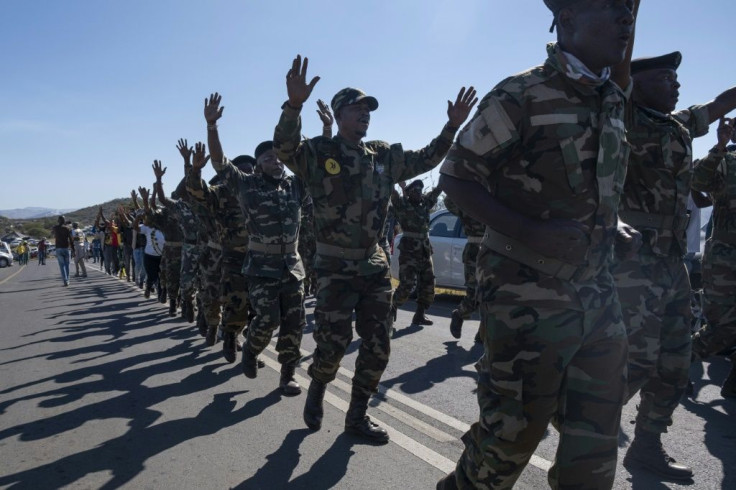 Military veterans of the anti-apartheid struggle marched on the road outside Zuma's home