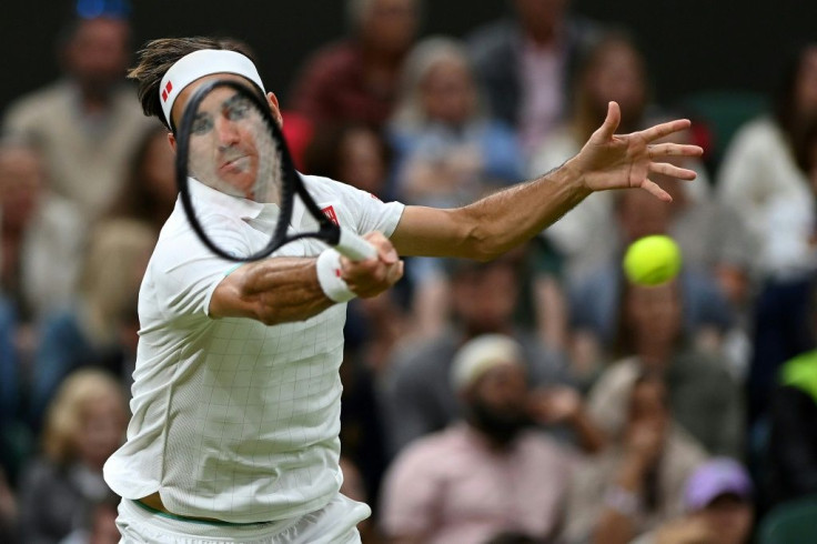 Rolling on: Roger Federer returns against Italy's Lorenzo Sonego