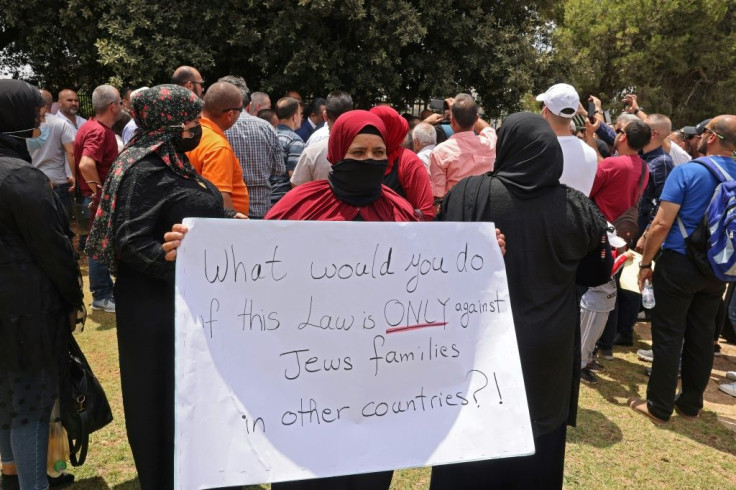 Israeli Arabs protest outside parliament ahead of a vote in which lawmakers failed to extend a ban on them extending their rights to their Palestinians spouses