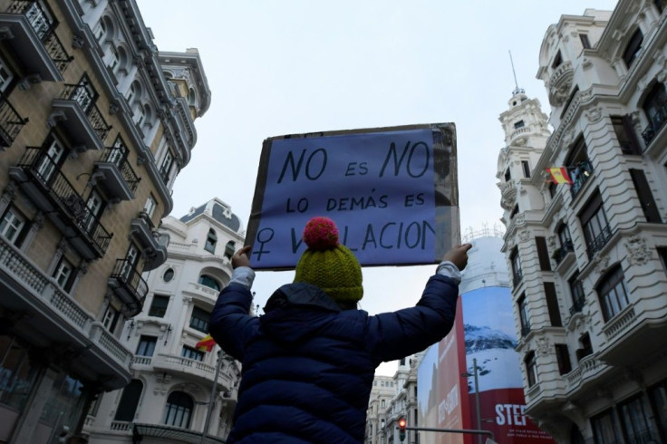 A woman holds a placard reading, "No is no, the rest is rape" during a demonstration marking the International Women's Day in Madrid on March 8, 2020