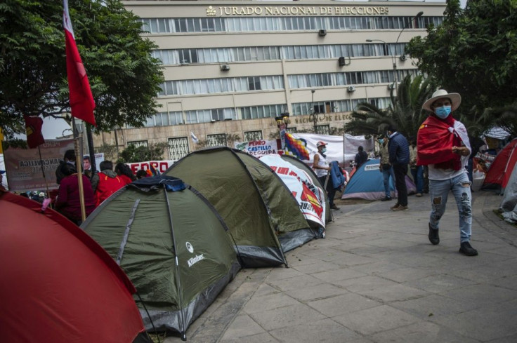 Supporters of Peru's left-wing presidential candidate Pedro Castillo camp outside the building of the National Jury of Elections in Lima on July 06, 2021