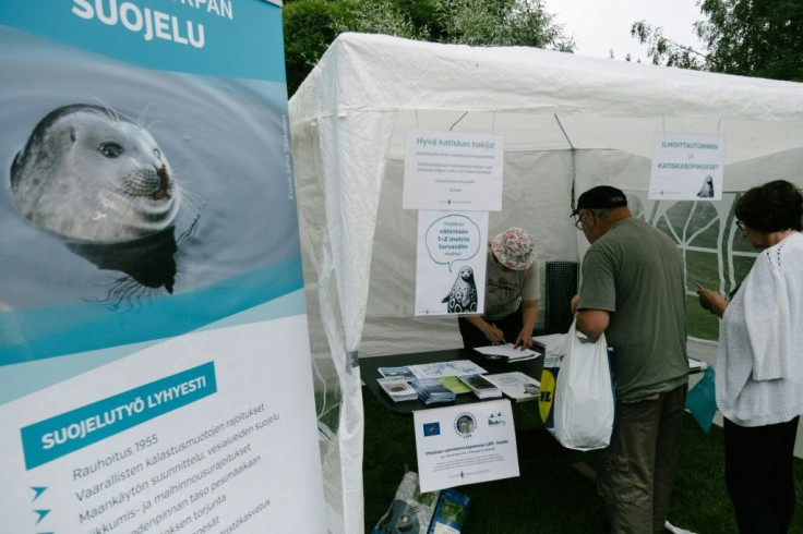 People queue to sign a pledge to stop using fishing nets on Lake Saimaa