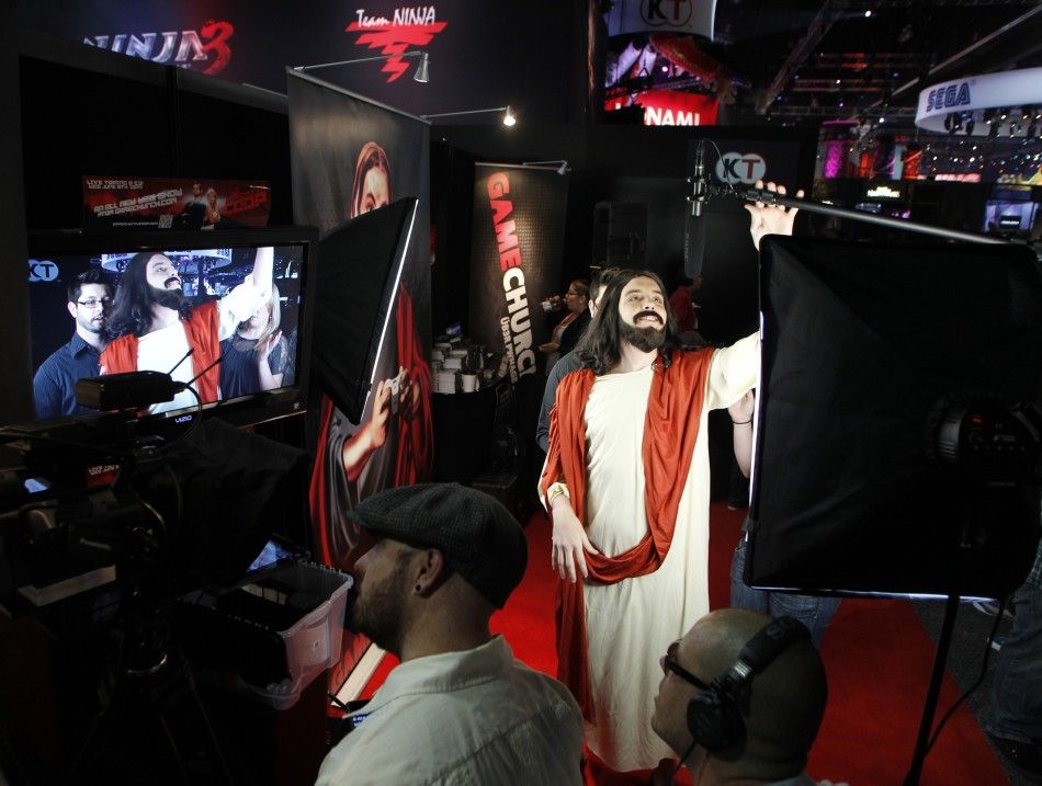 A man dressed as Jesus Christ grabs a microphone during a taping of a webisode for gaming website gamechurch.com during E3 in Los Angeles