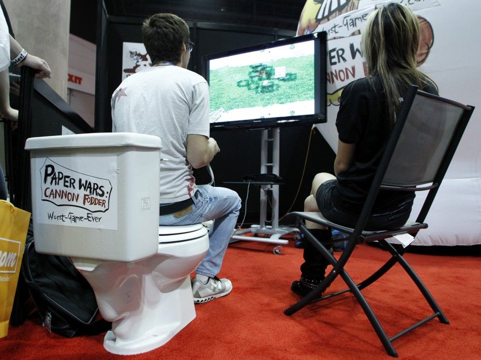 A gamer sits on a toilet bowl as he plays the video game quotPaper Wars Cannon Fodderquot by developer iFun4All during E3 in Los Angeles