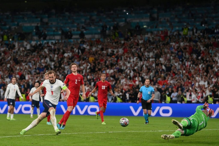 Harry Kane slams home the rebound for the winning goal after Kasper Schmeichel saved his extra-time penalty