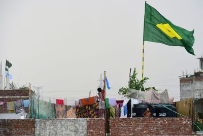 A child hoists the national flag of Argentina on the outskirts of Dhaka during the 2018 World Cup