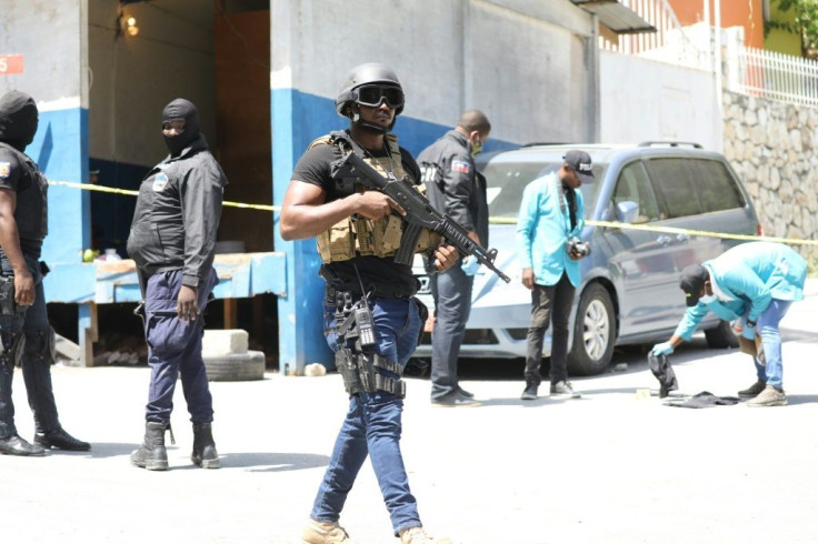 Haitian police and forensics teams look for evidence outside the presidential residence following the assassination of president Jovenel Moise