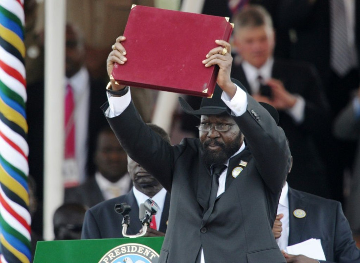South Sudanese President Salva Kiir brandishes  the country's new constitution on July 9, 2011