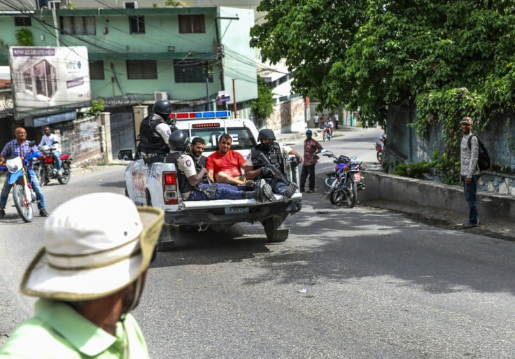 Two men, accused of being involved in Moise's assassination, are being transported to a police station in Port au Prince