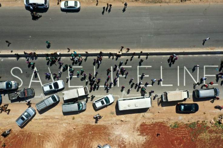 Members of civil society, humanitarian aid, medical and rescue services formed a human chain in a campaign for renewal of a UN resolution authorizing the passage of aid into Syria's rebel-held northwest on July 2, 2021