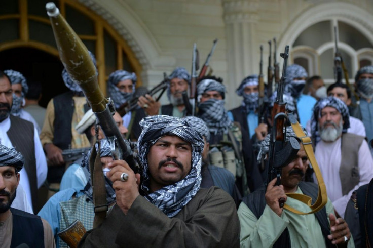 Militia members gather with their weapons to support Afghanistan security forces against the Taliban, in warlord Ismail Khan's house in Herat