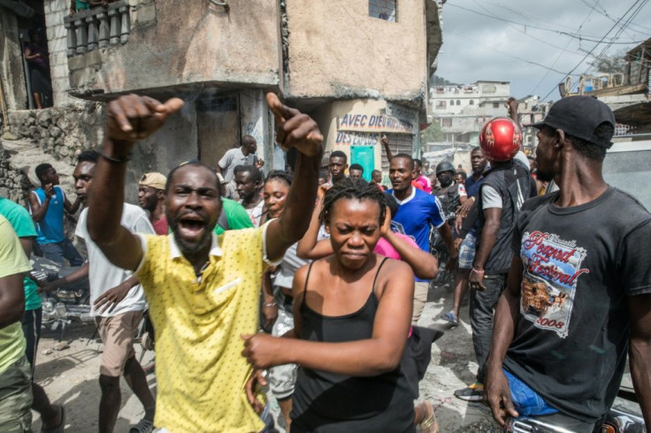 The crowd reacts at the Jalousie township as armed men, accused of being involved in the assassination of President Jovenel Moise, are being arrested in Port au Prince on July 8, 2021