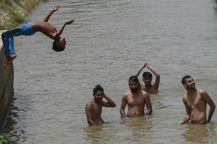 Boys and men young and old -- but not women in socially conservative Rajasthan -- cool off in the muddy water of an irrigation canal