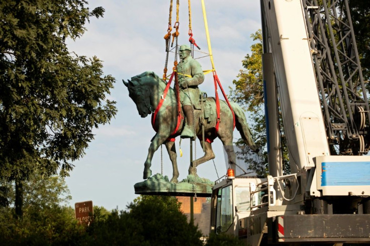 Workers remove the statue of Confederate general Robert E. Lee from a park in the southern US city of Charlottesville, where it had been the focal point of protests