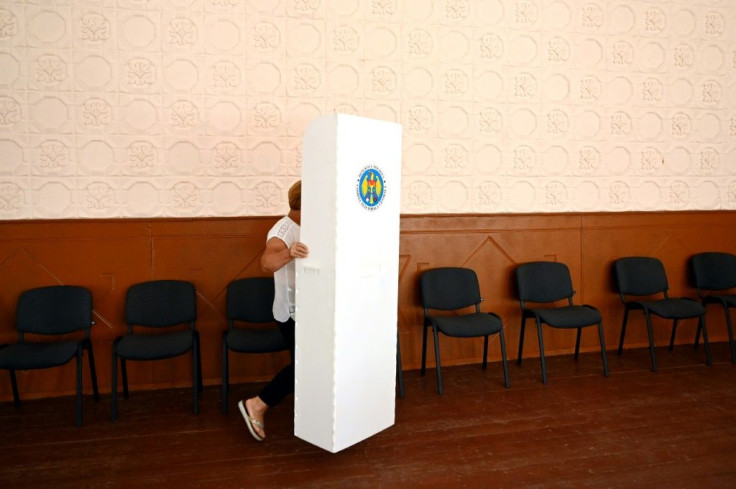 An election worker sets up a voting booth in the Moldovan village of Valea-Trestieni, north of Chisinau