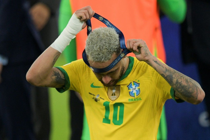 Neymar takes off his runner-up medal after Brazil lost the Copa America final 1-0 to arch rivals Argentina