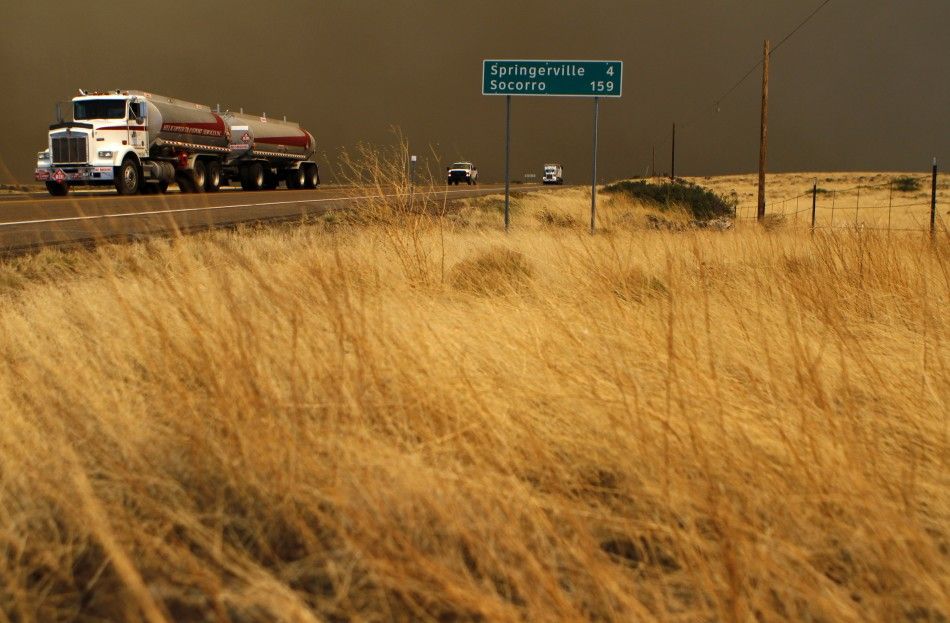 Motorist travel along U.S. Highway 60 as smoke from the Wallow Wildfire fills the sky in Springerville