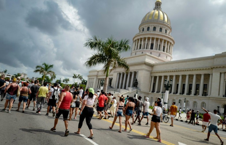 Cubans march in front of Havana's Capitol during a demonstration against the government of Cuban President Miguel Diaz-Canel