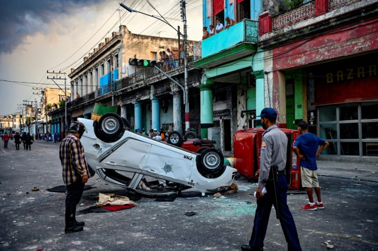 Police cars overturned in the street