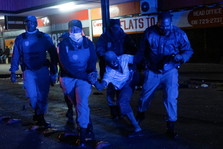 Johannesburg police detaining a suspected looter in the city's business district