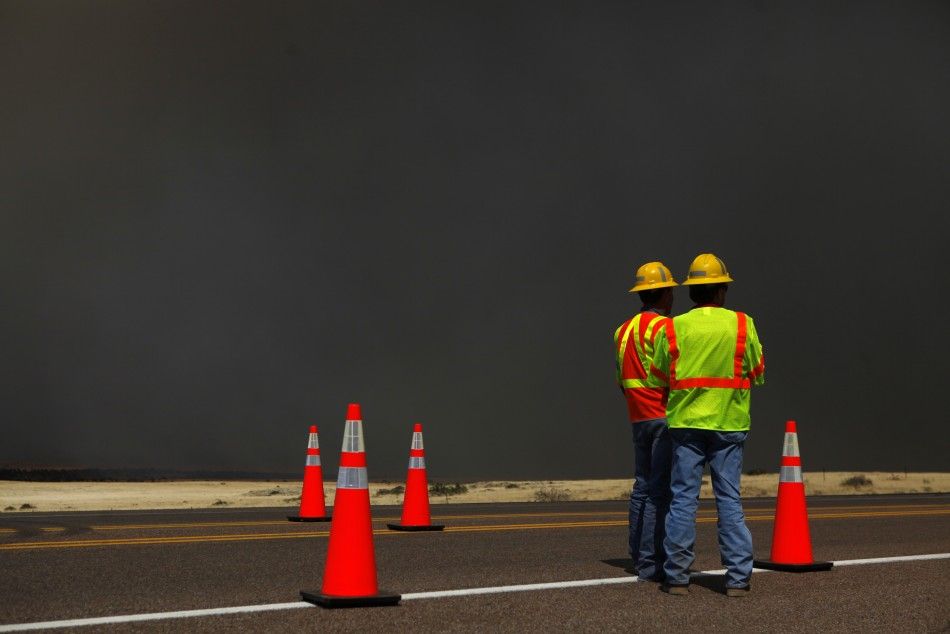 Arizona Department of Transportation workers prepare to close off a section of U.S. Highway 60 due to the Wallow Wildfire in Springerville