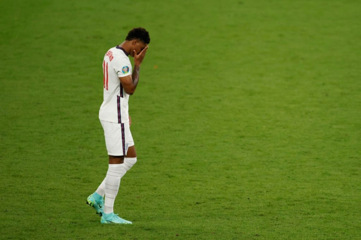 England's forward Marcus Rashford reacts after he fails to score in the penalty shootout during the UEFA EURO 2020 final football match between Italy and England at the Wembley Stadium in London on July 11, 2021