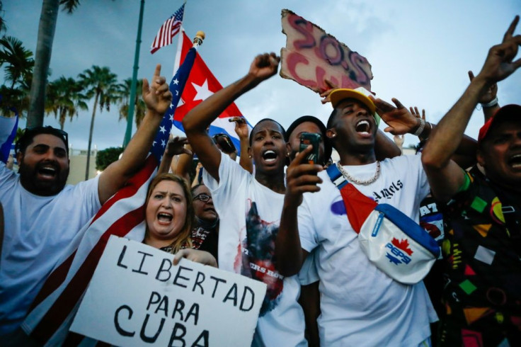 A woman holds a banner reading 'Freedom for Cuba' at a Miami rally supporting Cubans who have turned out in the largest popular protests since the 1959 revolution