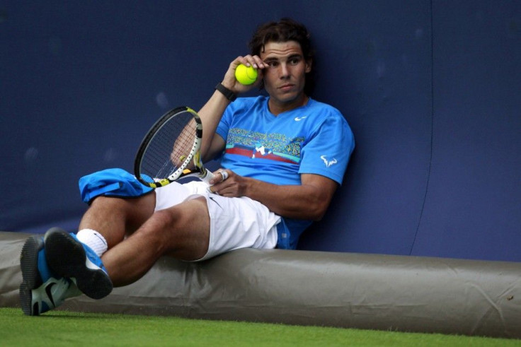 Nadal of Spain takes a break during a training session at the Queen's Club Championships in west London