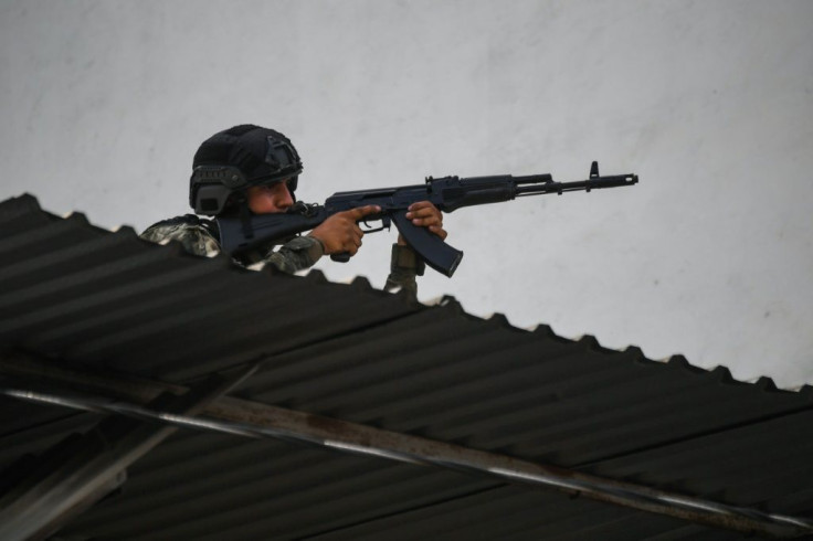 A member of Venezuela police in position after clashes with alleged members of a criminal gang at the Cota 905 neighborhood, in Caracas on July 9, 2021. President Nicolas Maduro said 10 Colombian paramilataries have died in recent clashes with security fo